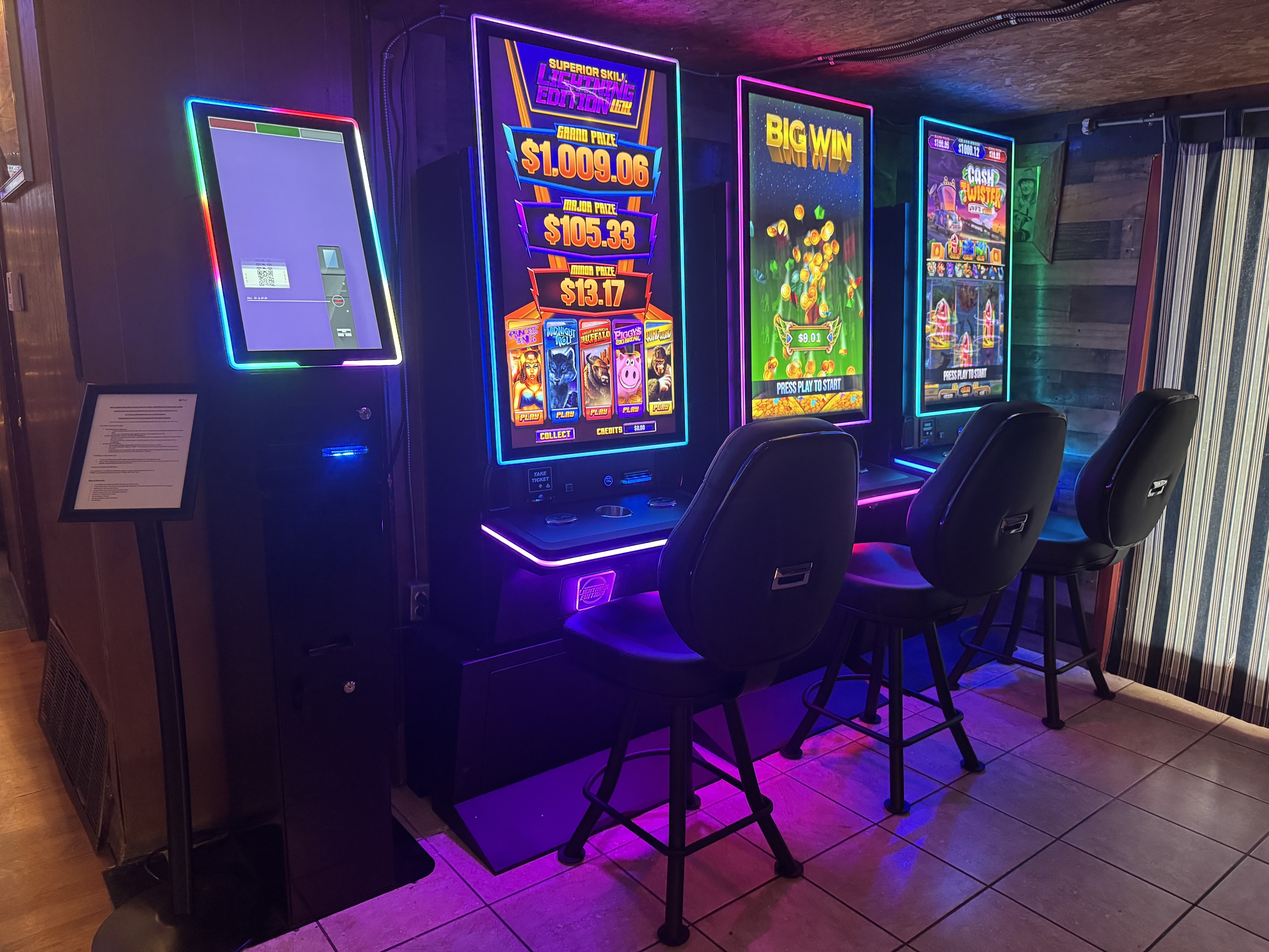 A row of sleek, vertical skill-based gaming machines inside a clean and busy Texas small business