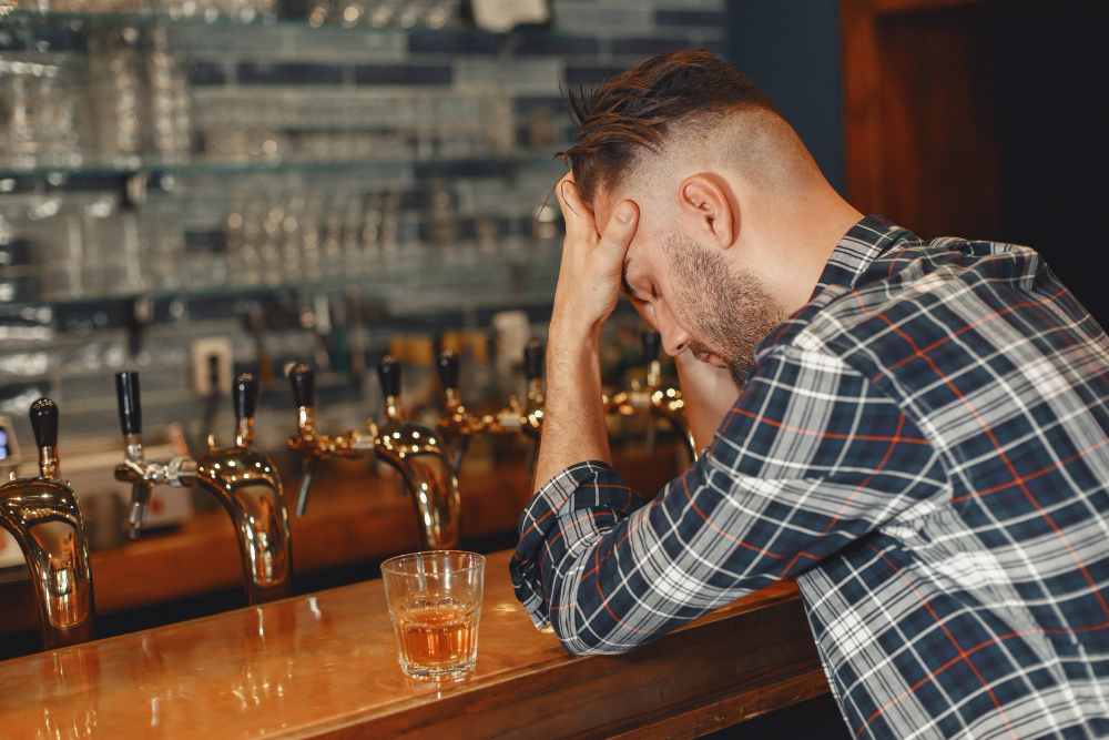 A bar owner with his head in his hands, illustrati