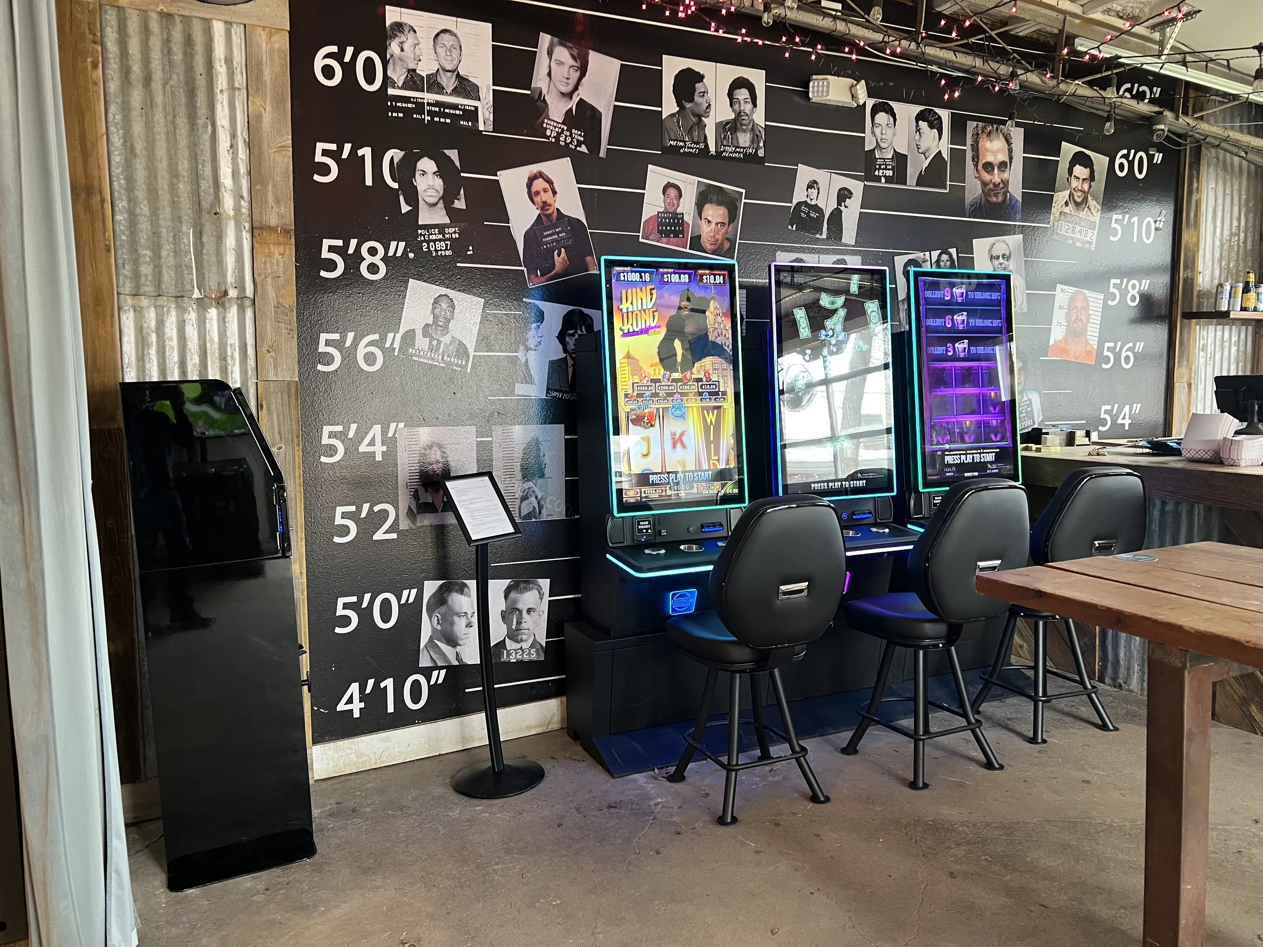 Three modern Texas skill game machines set up against a unique, themed wall in a bar, ready for patron entertainment.